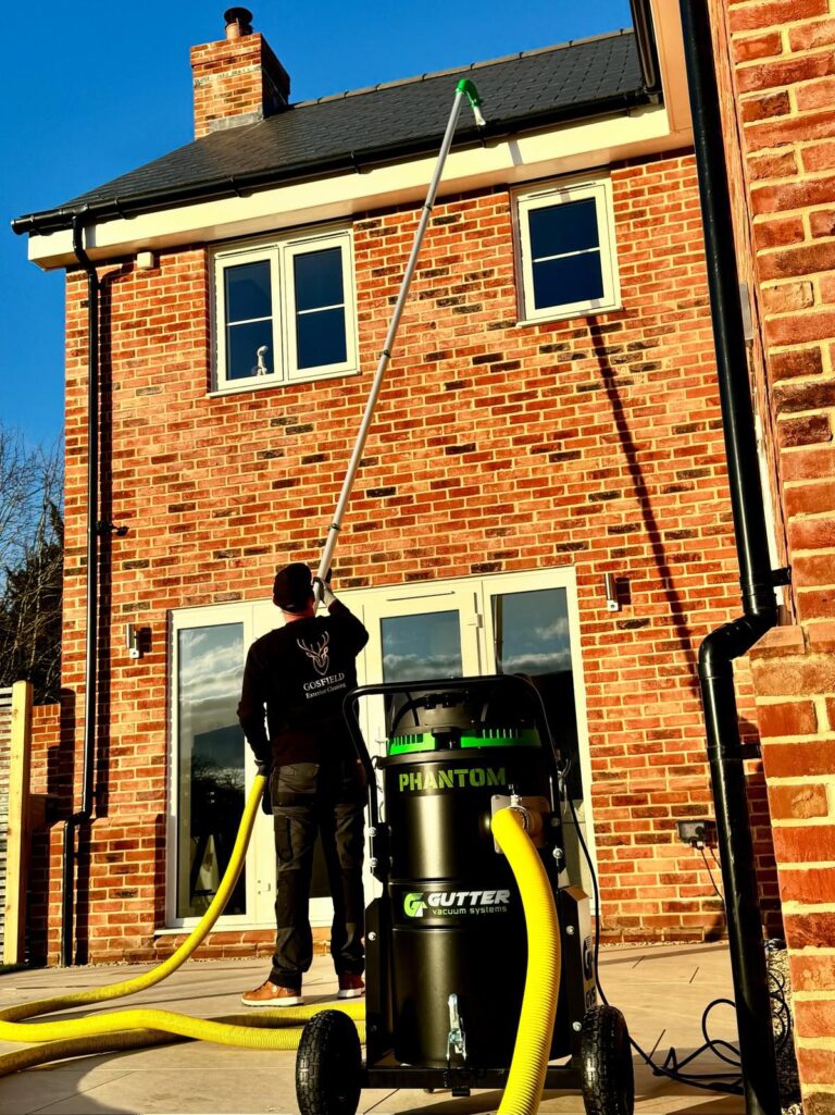 Technician using gutter vacuum system at property in Halstead Essex