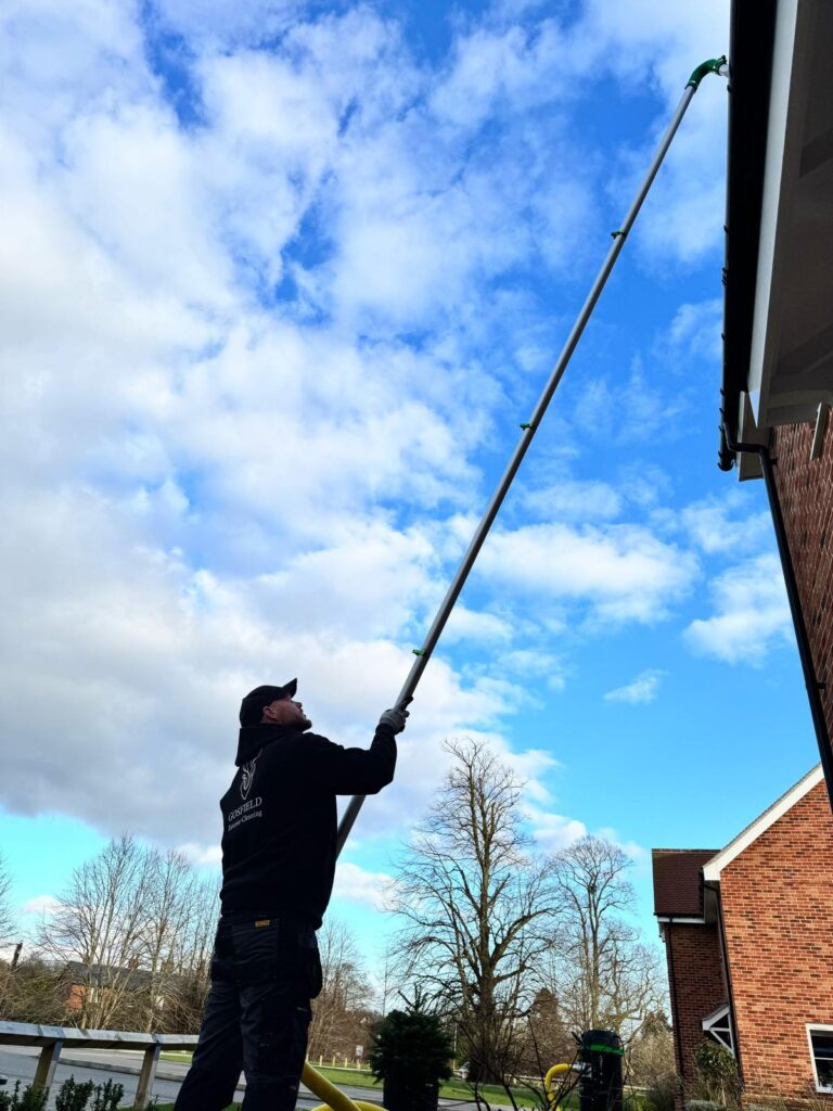 Technician clearing gutters at property in Maldon Essex