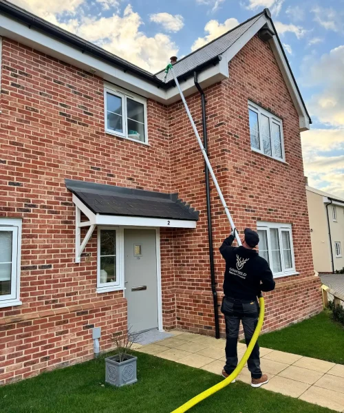 Gutter cleaning at a home in Gosfield using a high-reach vacuum system